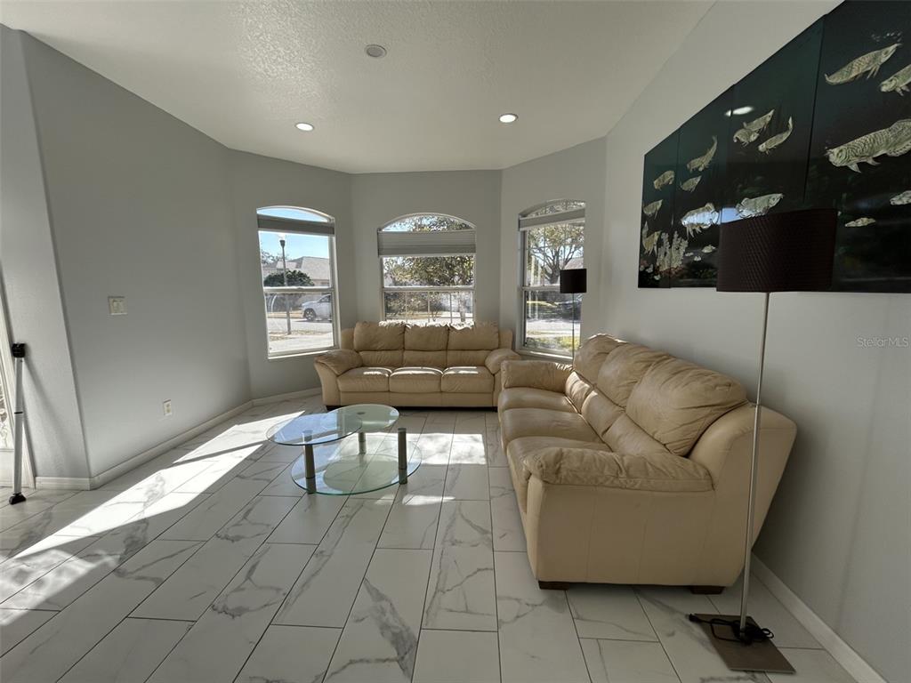 10439 Andover Point Circle Orlando, FL 32825 - Photo 11 of 33 a living room with furniture and a flat screen tv