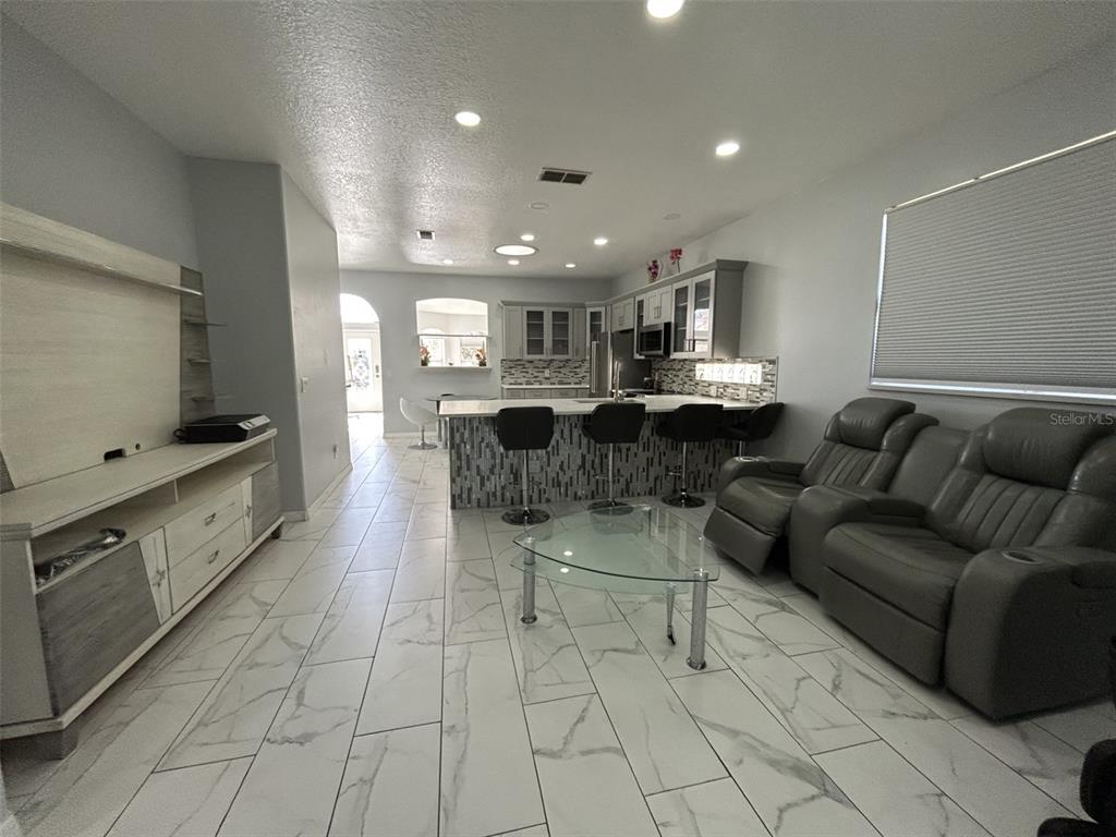 10439 Andover Point Circle Orlando, FL 32825 - Photo 16 of 33 a living room with furniture and a flat screen tv