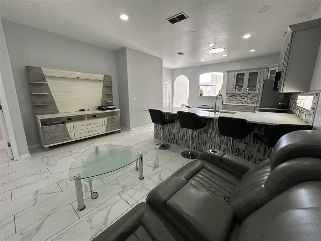 10439 Andover Point Circle Orlando, FL 32825 - Photo 17 of 33 a living room with furniture and a flat screen tv