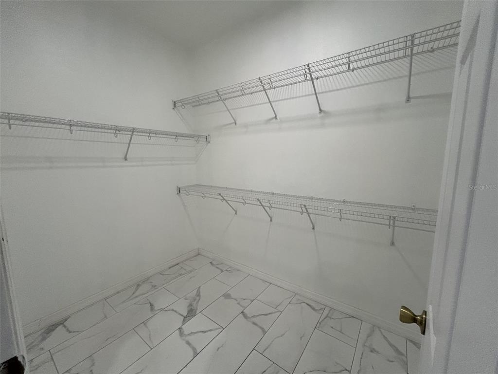 10439 Andover Point Circle Orlando, FL 32825 - Photo 20 of 33 a view of a room with racks on the wall
