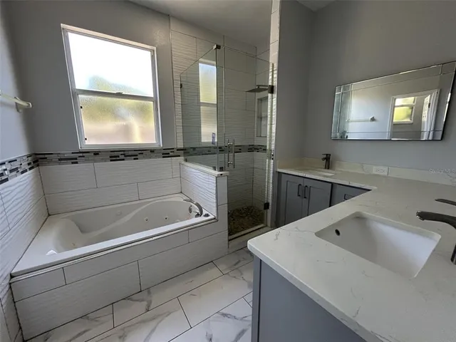a bathroom with a bathtub and a sink