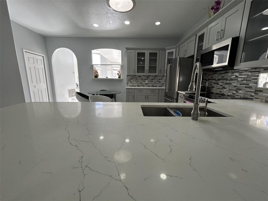 10439 Andover Point Circle Orlando, FL 32825 - Photo 8 of 33 a large kitchen with stainless steel appliances a large counter top