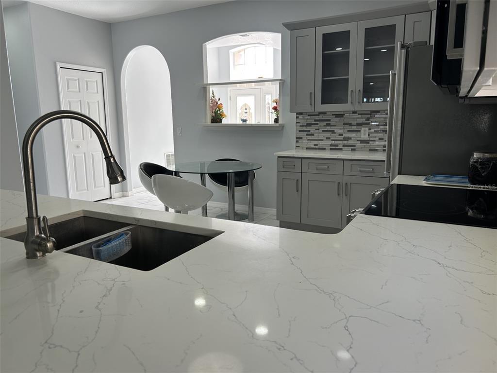 10439 Andover Point Circle Orlando, FL 32825 - Photo 9 of 33 a kitchen with a stove a sink and a refrigerator