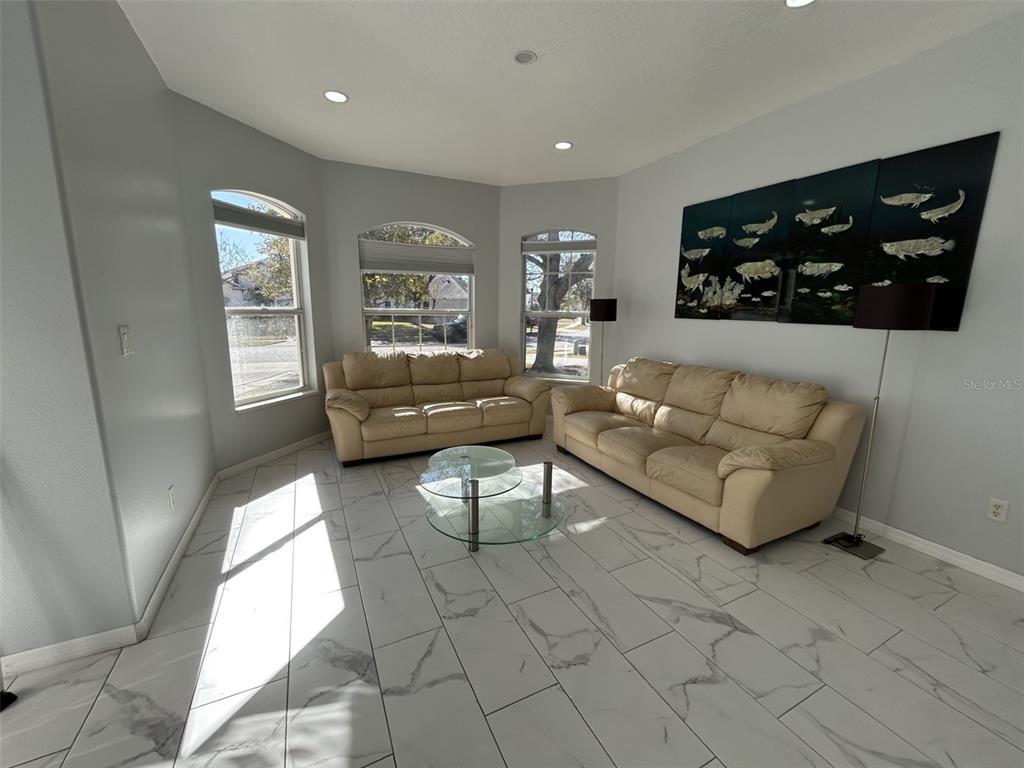 10439 Andover Point Circle Orlando, FL 32825 - Photo 10 of 33 a living room with furniture and a flat screen tv