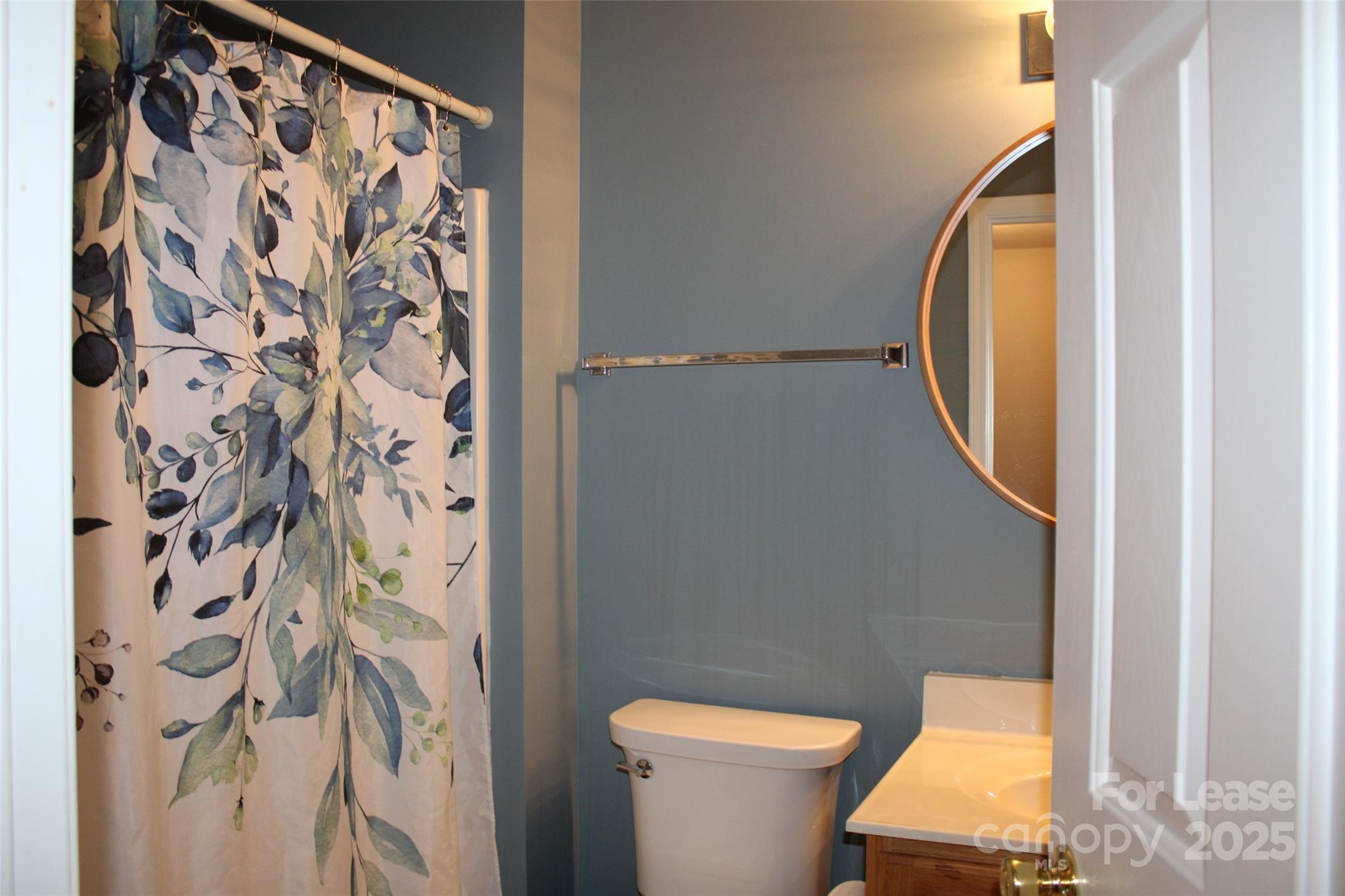 18630 Oakhurst Boulevard Cornelius, NC 28031 - Photo 11 of 20 a bathroom with a toilet and a mirror
