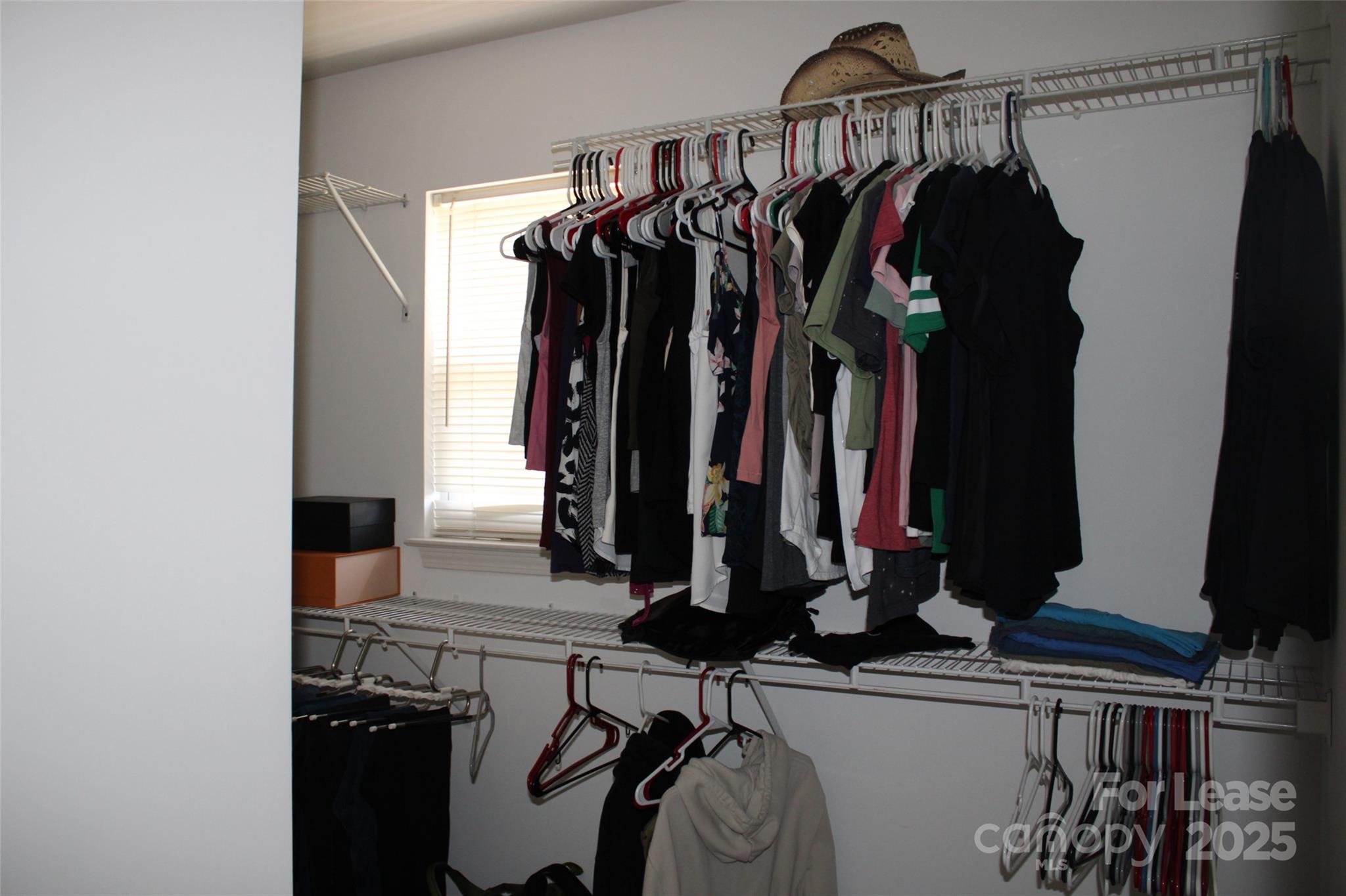 18630 Oakhurst Boulevard Cornelius, NC 28031 - Photo 12 of 20 a view of walk in closet with clothes and shoes