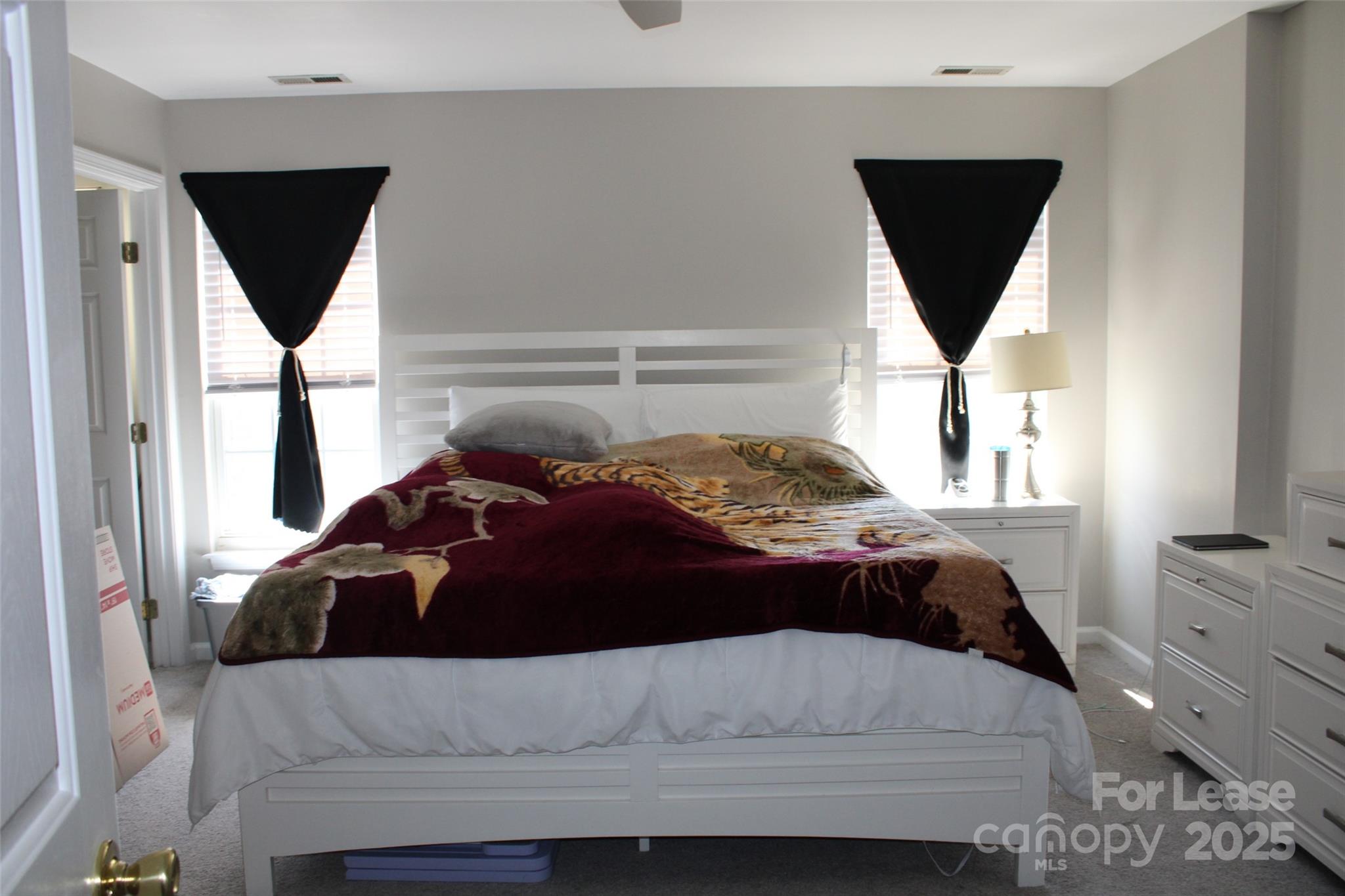 18630 Oakhurst Boulevard Cornelius, NC 28031 - Photo 9 of 20 a bedroom with a bed and a window