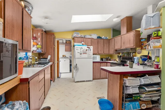 a kitchen with refrigerator and cabinets