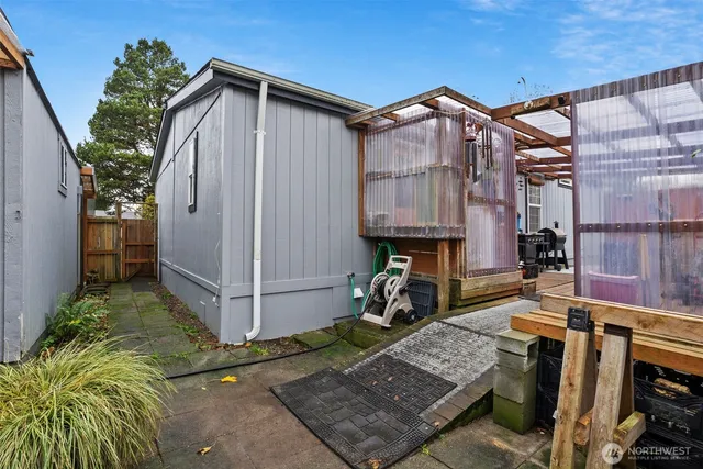a view of a porch with furniture and a grill