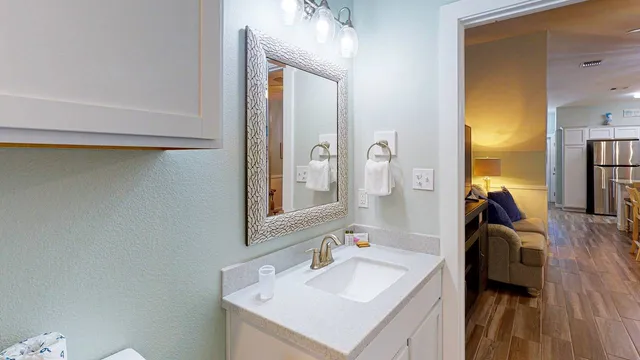 a en suite bathroom with a sink and a mirror