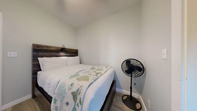 a bed sitting in a bedroom next to a window