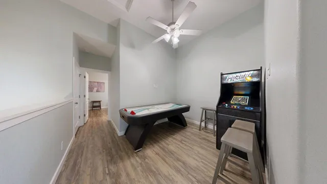 a living room with furniture and a wooden floor