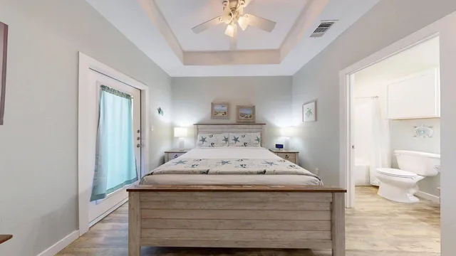 a spacious bedroom with a bed and a chandelier