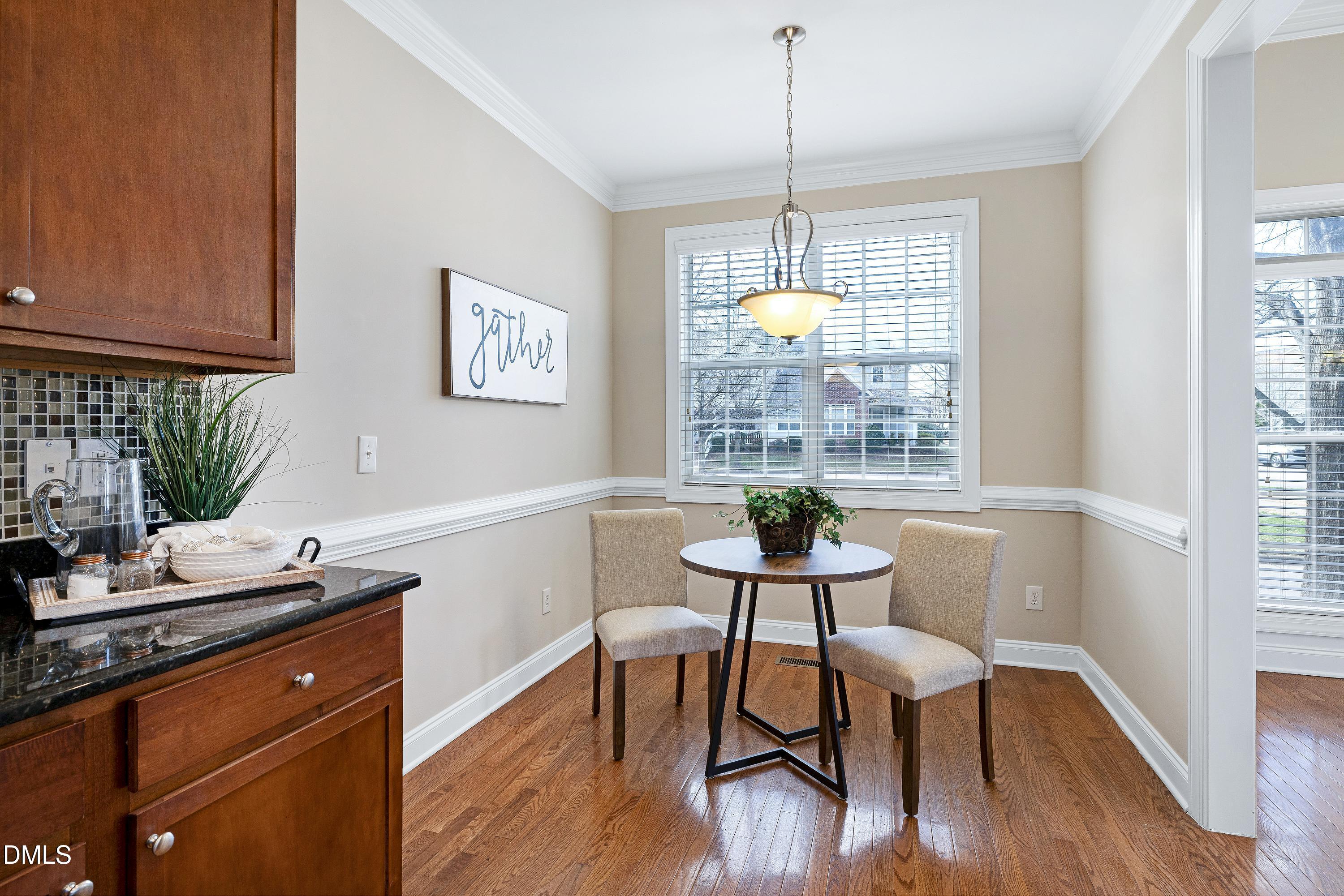 678 Democracy Street Raleigh, NC 27603 - Photo 17 of 67 a view of a dining room with furniture window and wooden floor