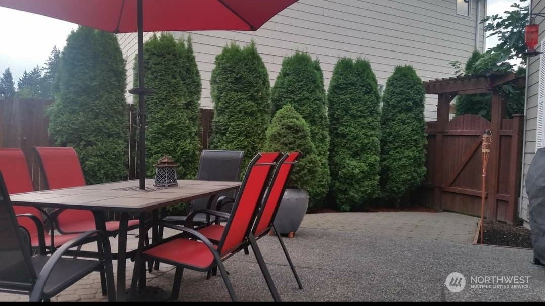113 181st Street Southwest Bothell, WA 98012 - Photo 25 of 26 a patio with a table and chairs and potted plants