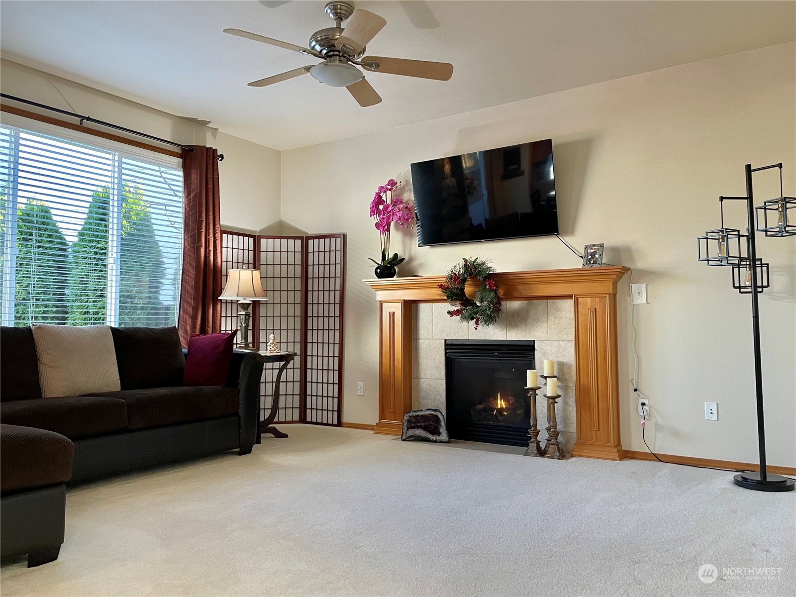 113 181st Street Southwest Bothell, WA 98012 - Photo 5 of 26 a living room with furniture a flat screen tv and a fireplace