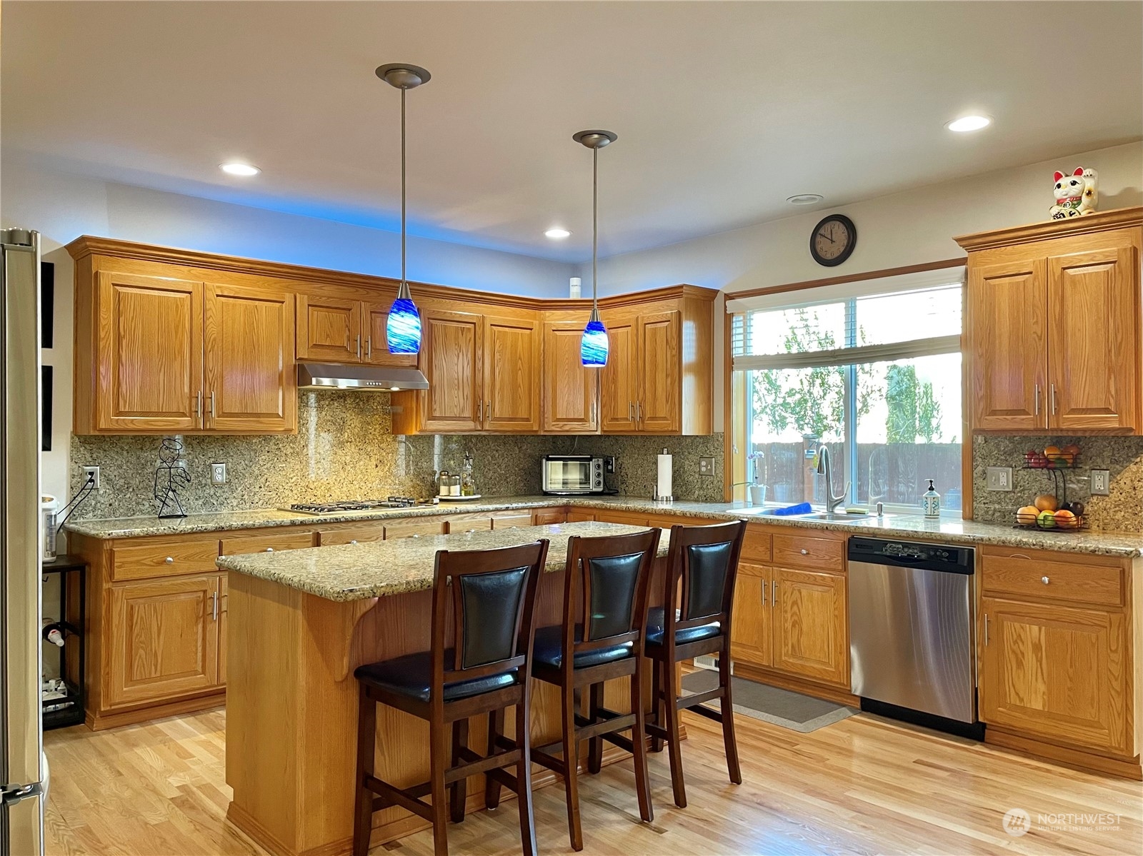 113 181st Street Southwest Bothell, WA 98012 - Photo 9 of 26 a kitchen with stainless steel appliances granite countertop wooden floor window and cabinets