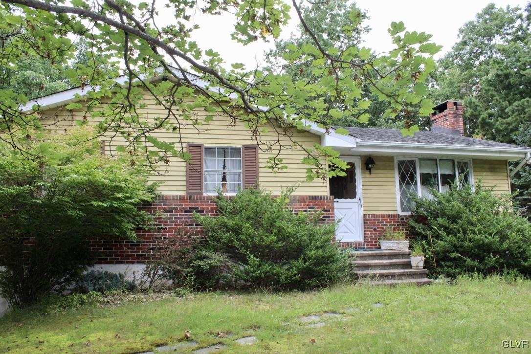 2765 Jackson Road Stroudsburg, PA 18360 - Photo 1 of 29 a front view of a house with a yard and shrubs