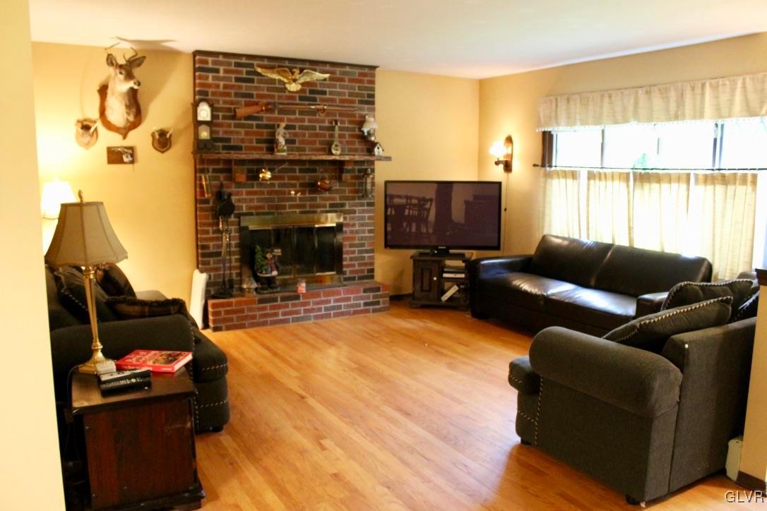 2765 Jackson Road Stroudsburg, PA 18360 - Photo 4 of 29 a living room with furniture a fireplace and a flat screen tv