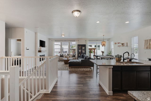 1002 South Yarrow Drive Mapleton, UT 84664 - Photo 7 of 39 Open-concept living area with dark wood-finish flooring
