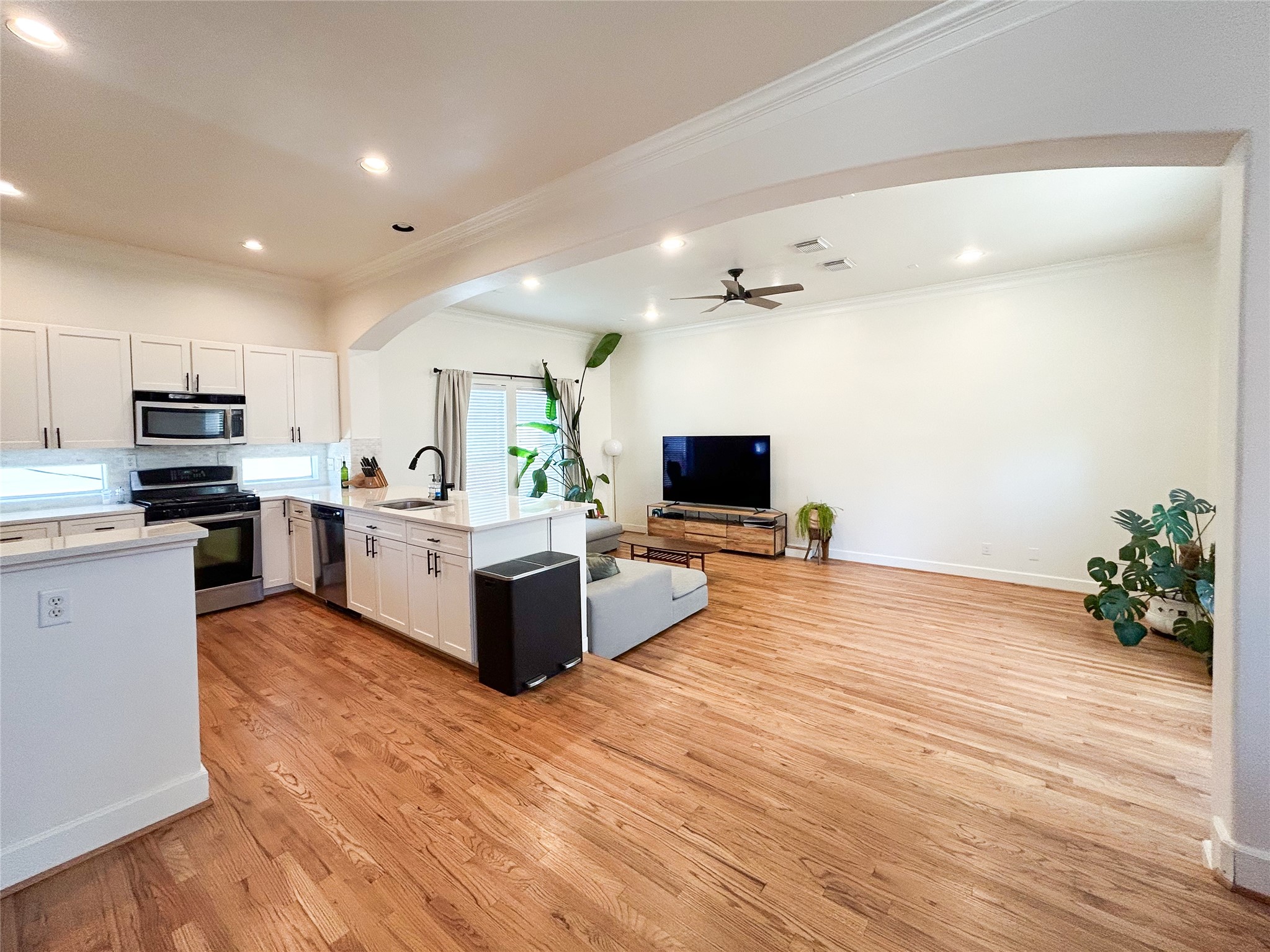 1128 West 26th Street Houston, TX 77008 - Photo 12 of 34 a large kitchen with kitchen island a counter top space a sink and stainless steel appliances