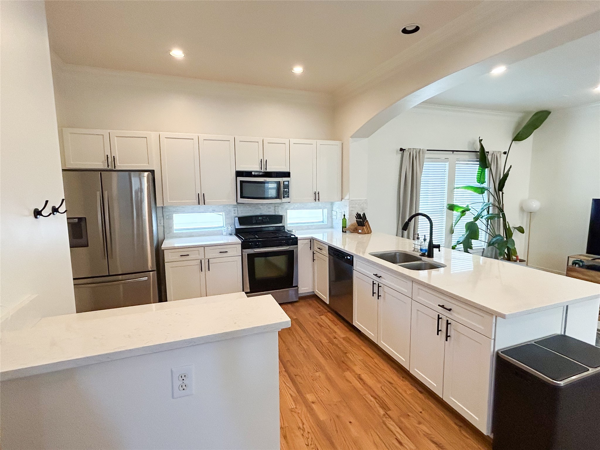 1128 West 26th Street Houston, TX 77008 - Photo 15 of 34 a kitchen with white cabinets and stainless steel appliances
