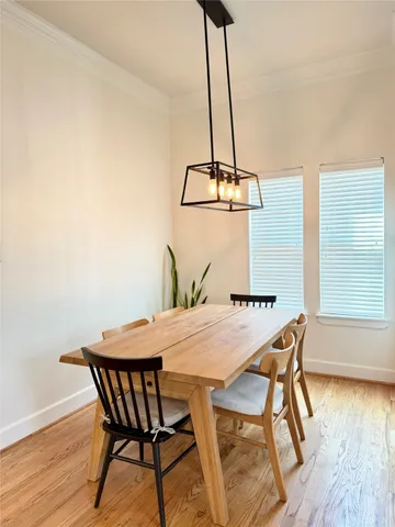 a view of a dining table chairs and a chandelier