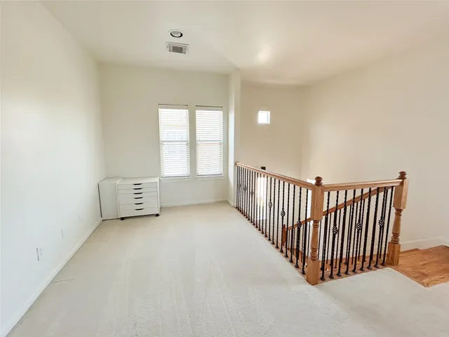 a view of an empty room with windows