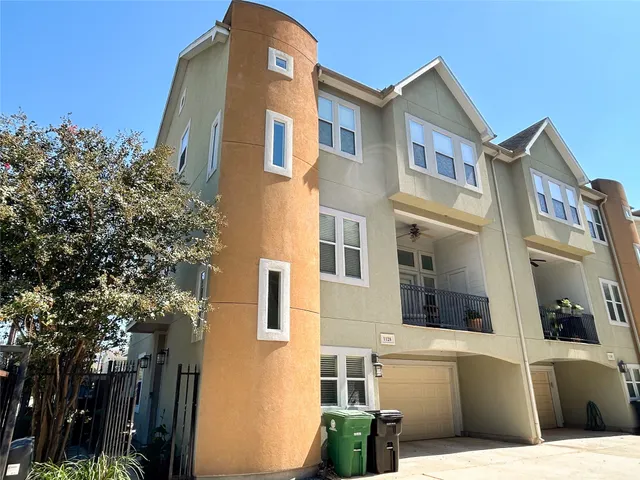 a front view of a building with a garden