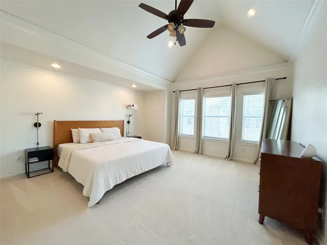 a spacious bedroom with a bed and a couch