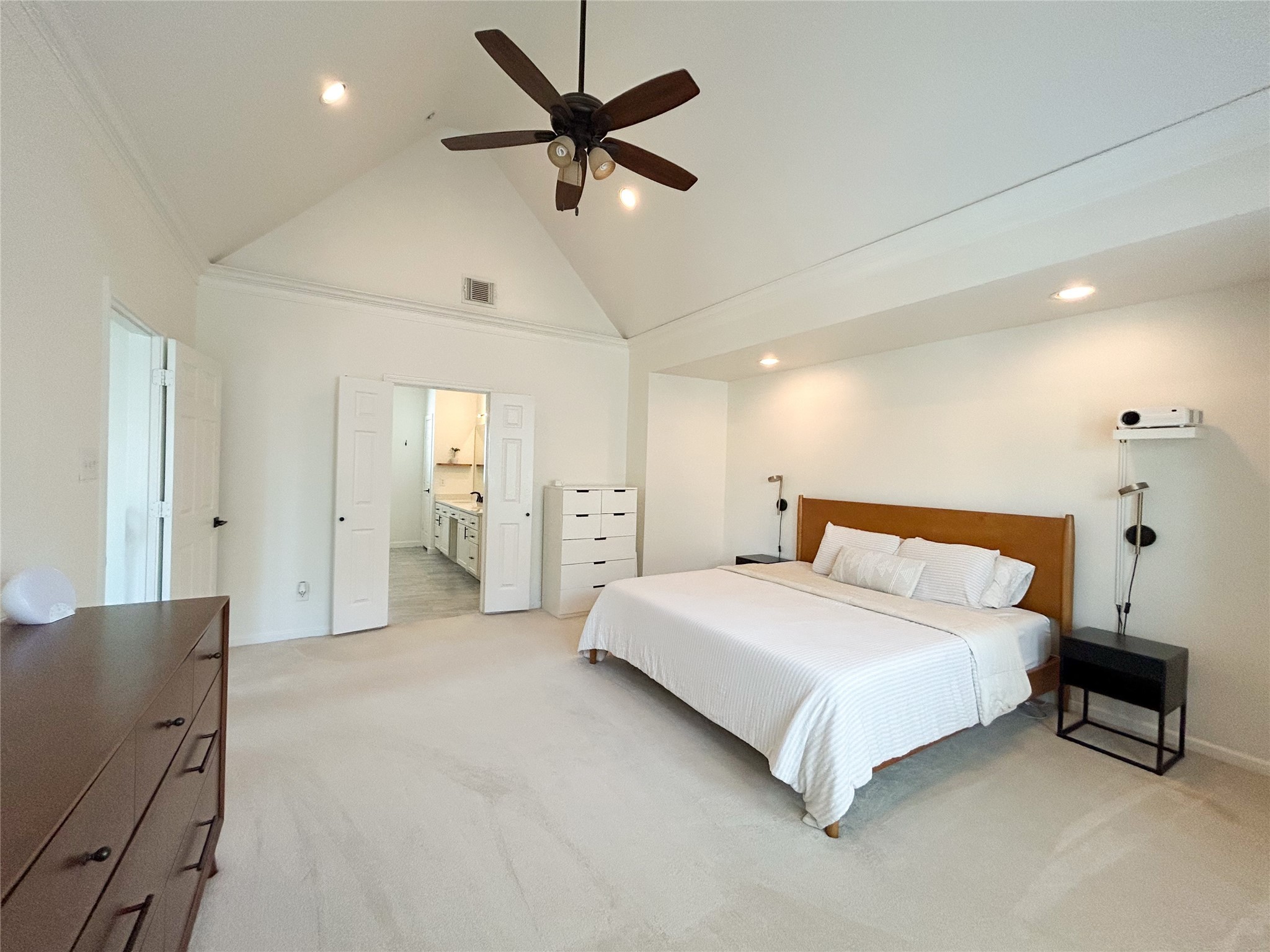 1128 West 26th Street Houston, TX 77008 - Photo 22 of 34 a spacious bedroom with a bed and a chandelier