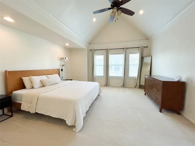 a spacious bedroom with a bed and window