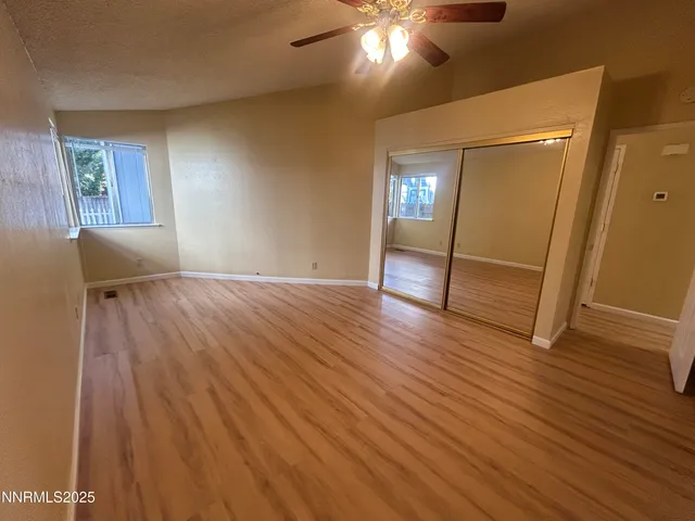 a view of empty room with wooden floor