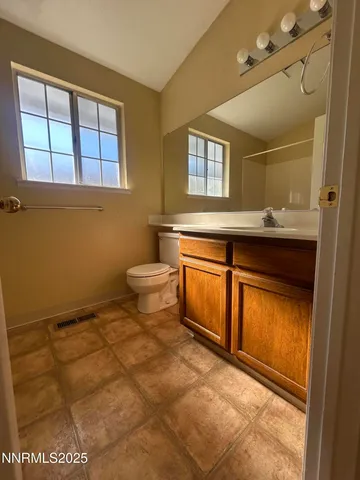a bathroom with a sink a toilet and mirror
