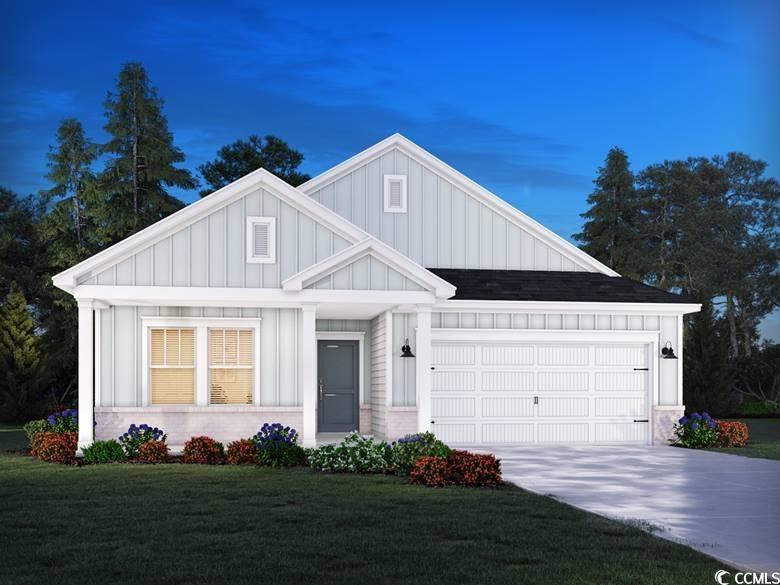 View of front of home with board and batten siding, a front lawn, driveway, an attached garage, and roof with shingles