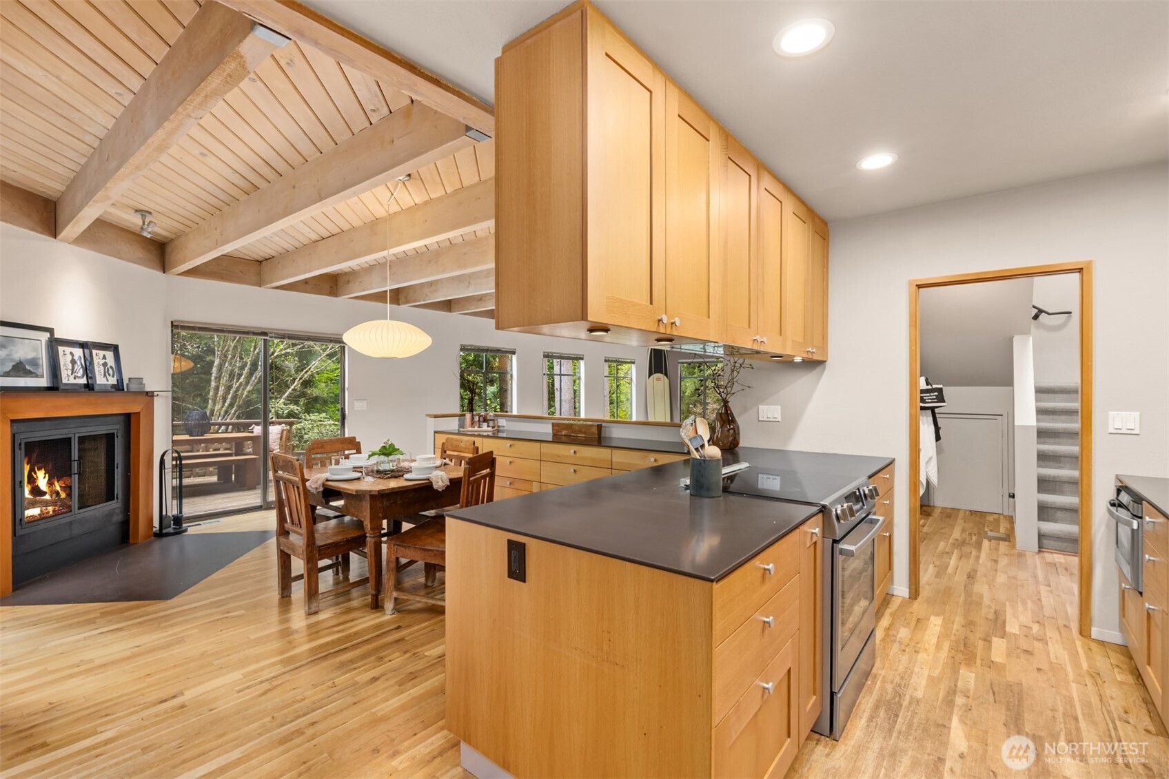 8151 Northeast Hidden Cove Road Bainbridge Island, WA 98110 - Photo 12 of 40 a kitchen with stainless steel appliances granite countertop sink stove top oven and cabinets