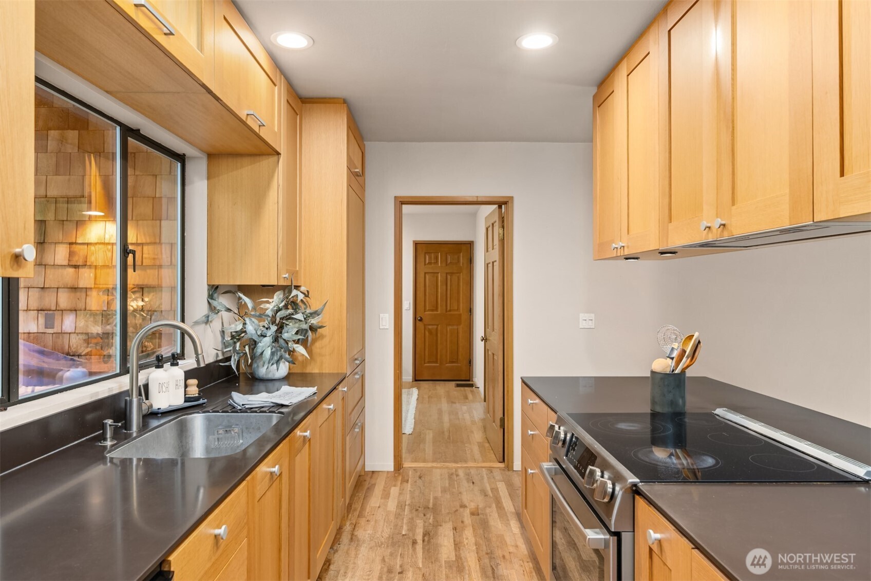 8151 Northeast Hidden Cove Road Bainbridge Island, WA 98110 - Photo 13 of 40 a kitchen with granite countertop a sink and a window