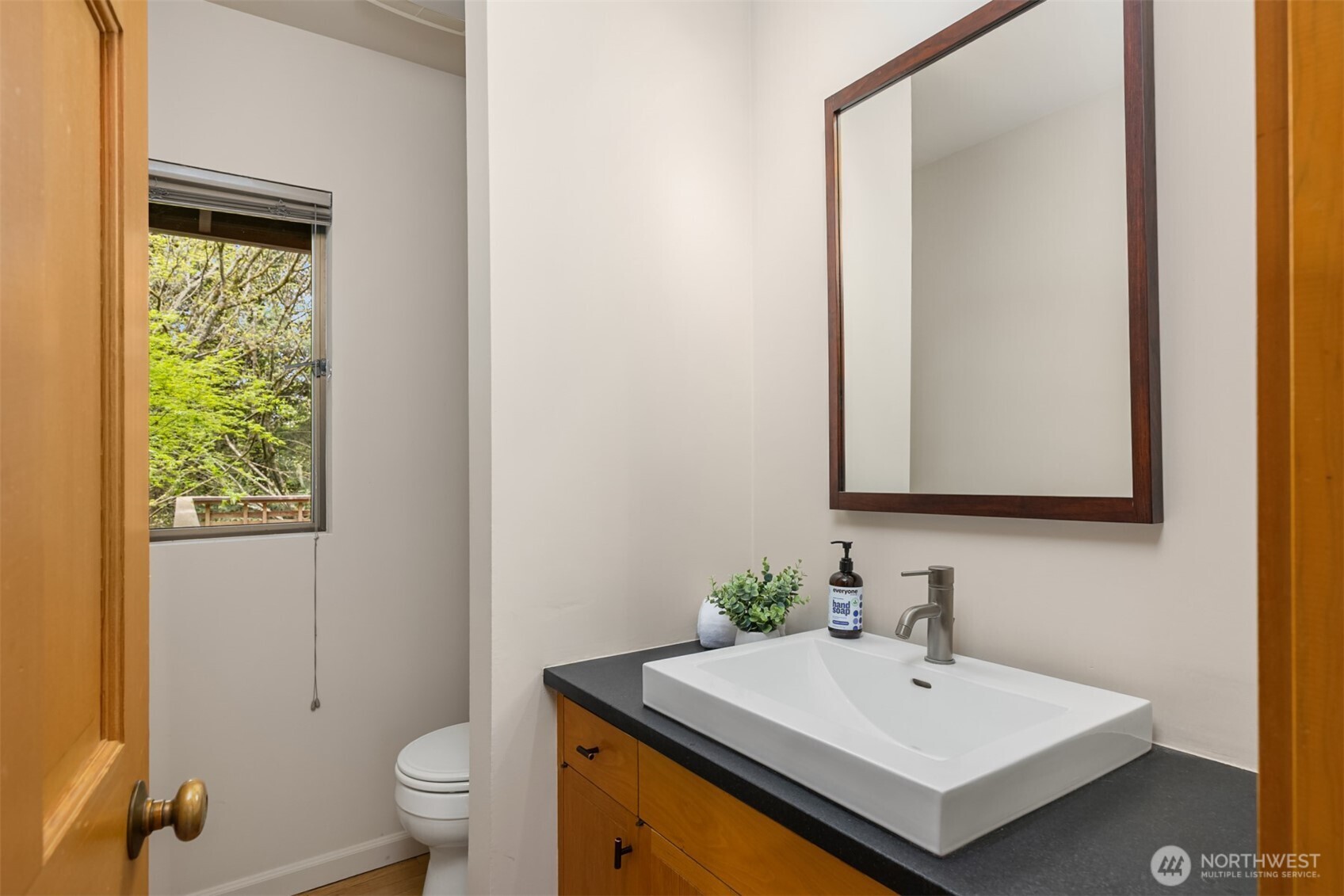 8151 Northeast Hidden Cove Road Bainbridge Island, WA 98110 - Photo 16 of 40 a bathroom with a sink and a mirror