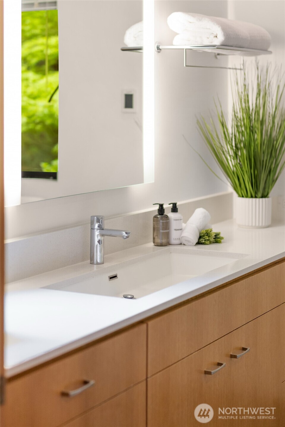 8151 Northeast Hidden Cove Road Bainbridge Island, WA 98110 - Photo 20 of 40 a bathroom with a sink a mirror and a potted plant