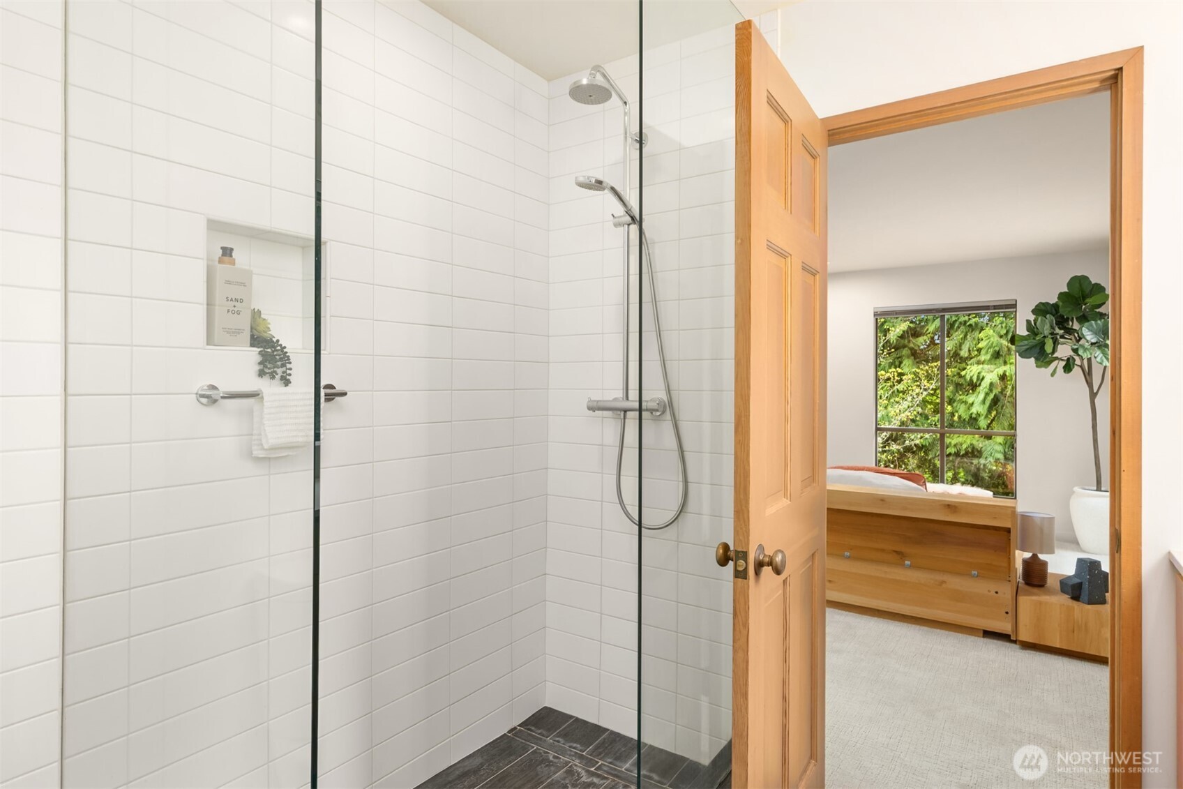 8151 Northeast Hidden Cove Road Bainbridge Island, WA 98110 - Photo 22 of 40 a bathroom with a shower and a window