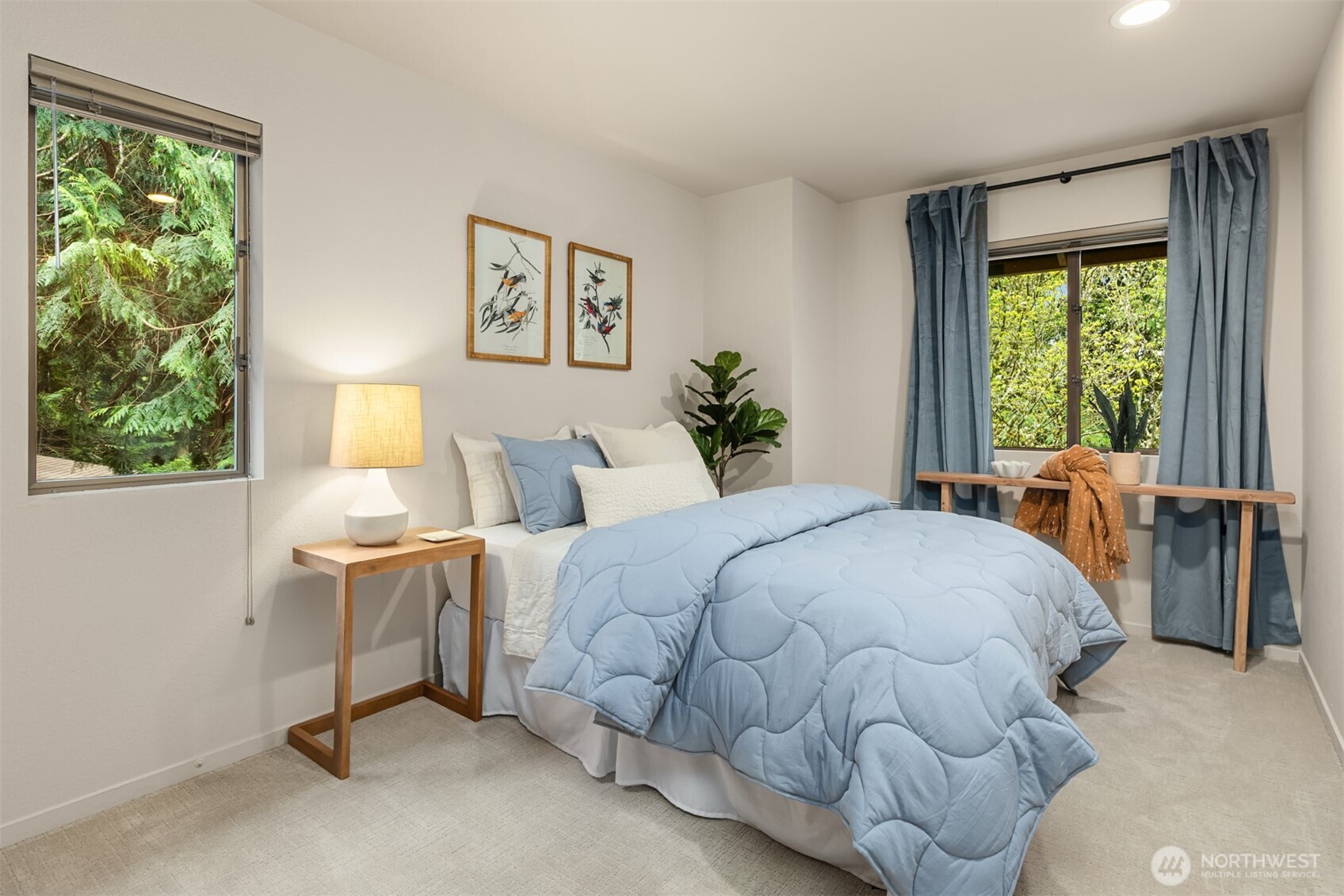 8151 Northeast Hidden Cove Road Bainbridge Island, WA 98110 - Photo 24 of 40 a large bed sitting in a bedroom next to a window