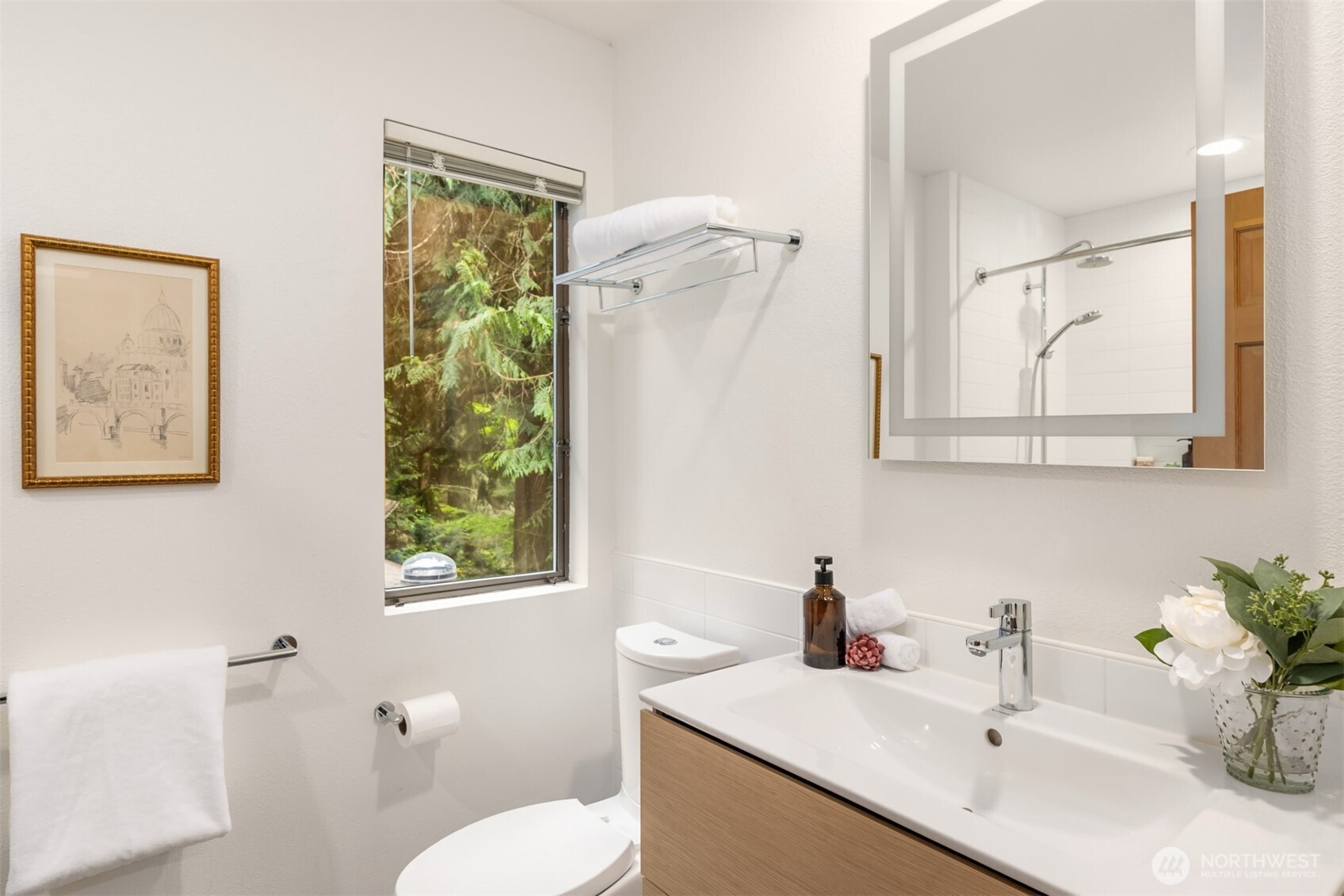 8151 Northeast Hidden Cove Road Bainbridge Island, WA 98110 - Photo 25 of 40 a bathroom with a sink and a mirror