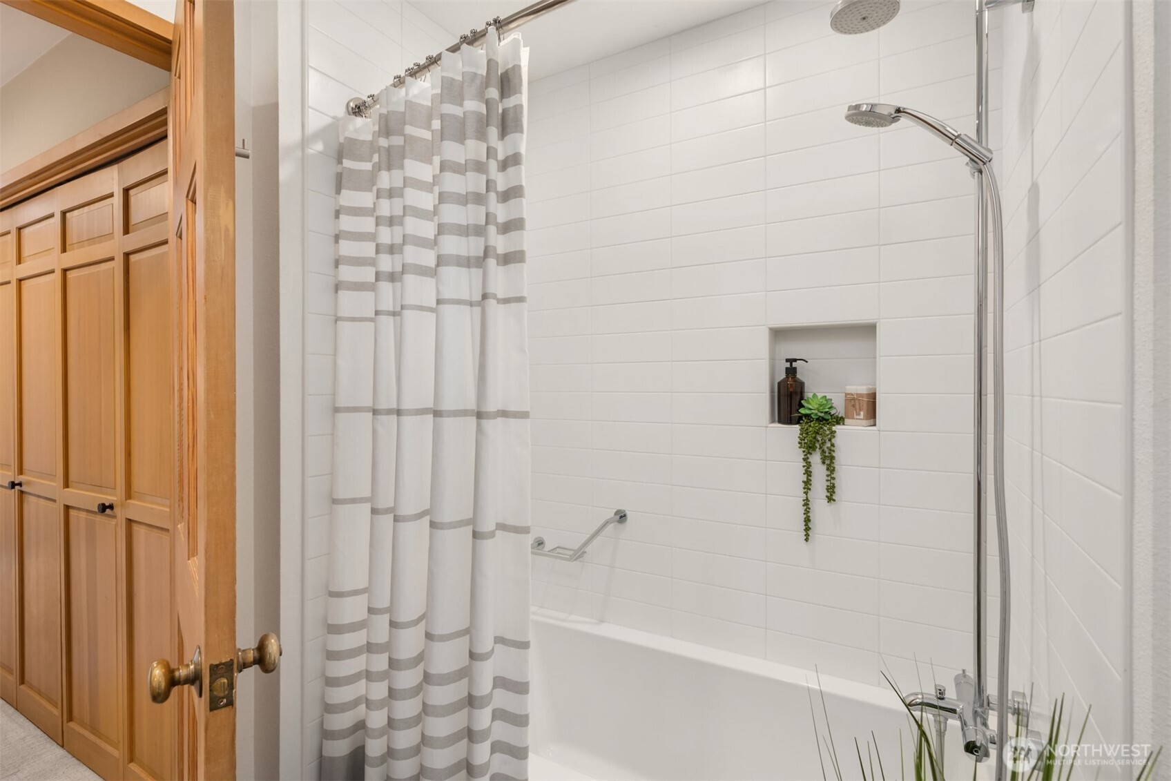 8151 Northeast Hidden Cove Road Bainbridge Island, WA 98110 - Photo 26 of 40 a bathroom with a bathtub and shower