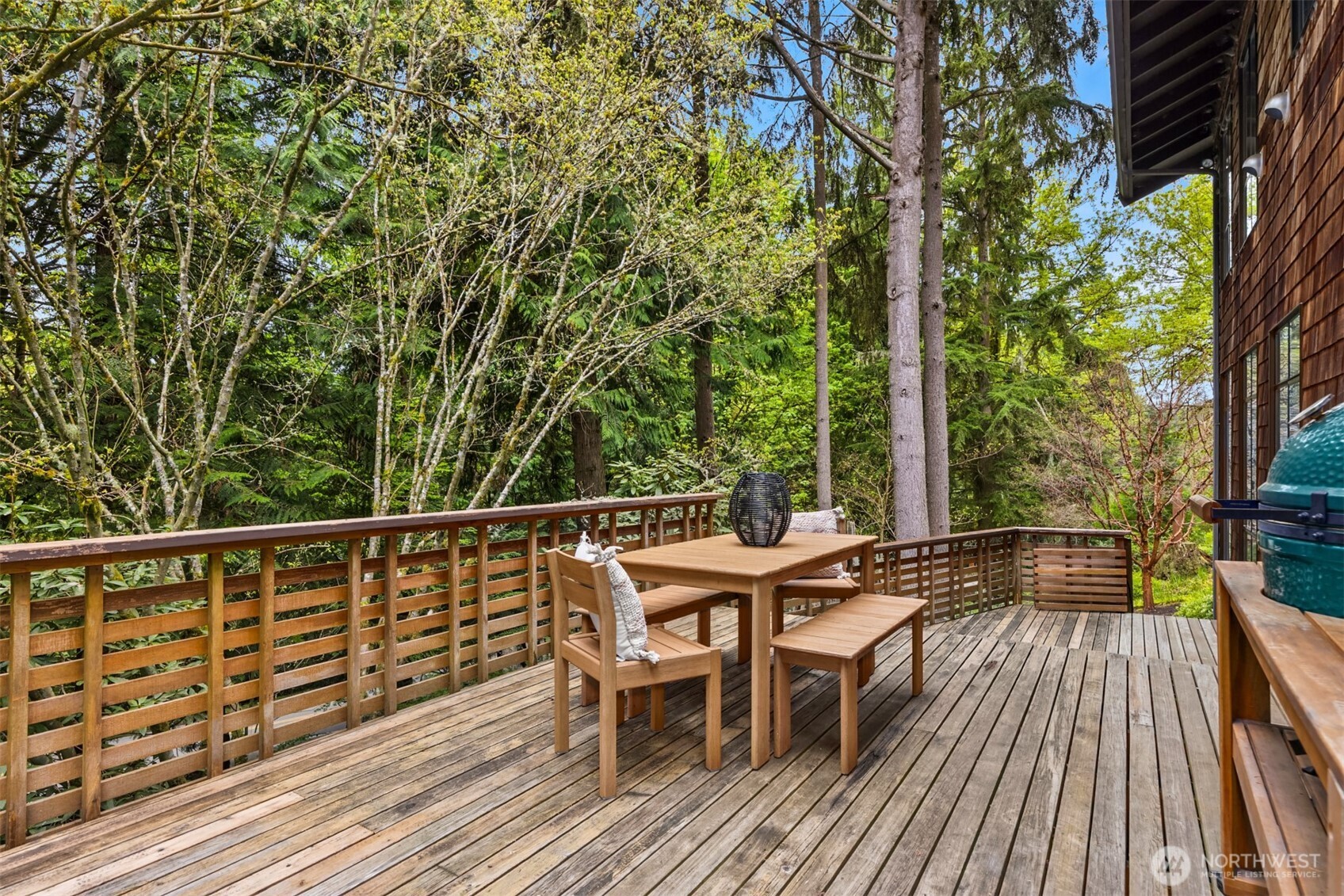 8151 Northeast Hidden Cove Road Bainbridge Island, WA 98110 - Photo 28 of 40 a balcony with wooden floor table and chairs