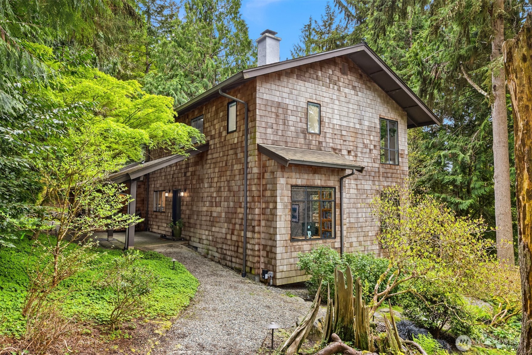 8151 Northeast Hidden Cove Road Bainbridge Island, WA 98110 - Photo 31 of 40 a front view of a house with garden