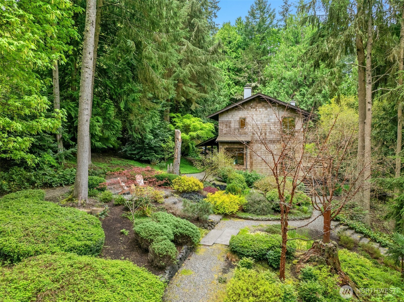 8151 Northeast Hidden Cove Road Bainbridge Island, WA 98110 - Photo 32 of 40 a backyard of a house with lots of green space