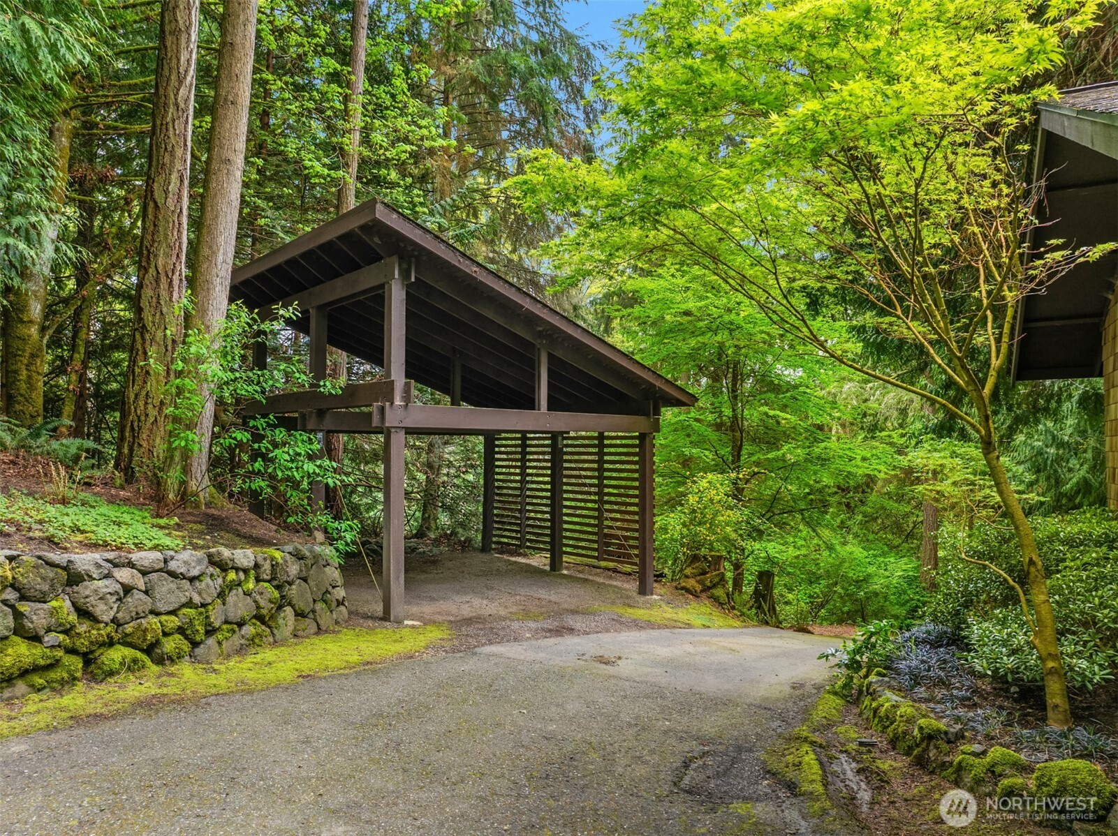 8151 Northeast Hidden Cove Road Bainbridge Island, WA 98110 - Photo 36 of 40 a view of a house with a small yard and plants