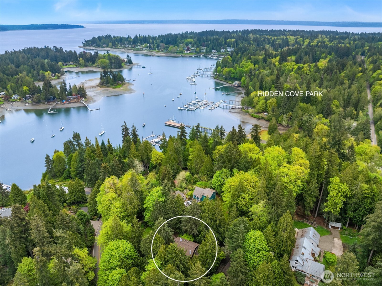 8151 Northeast Hidden Cove Road Bainbridge Island, WA 98110 - Photo 40 of 40 a view of a lake with a building in the back