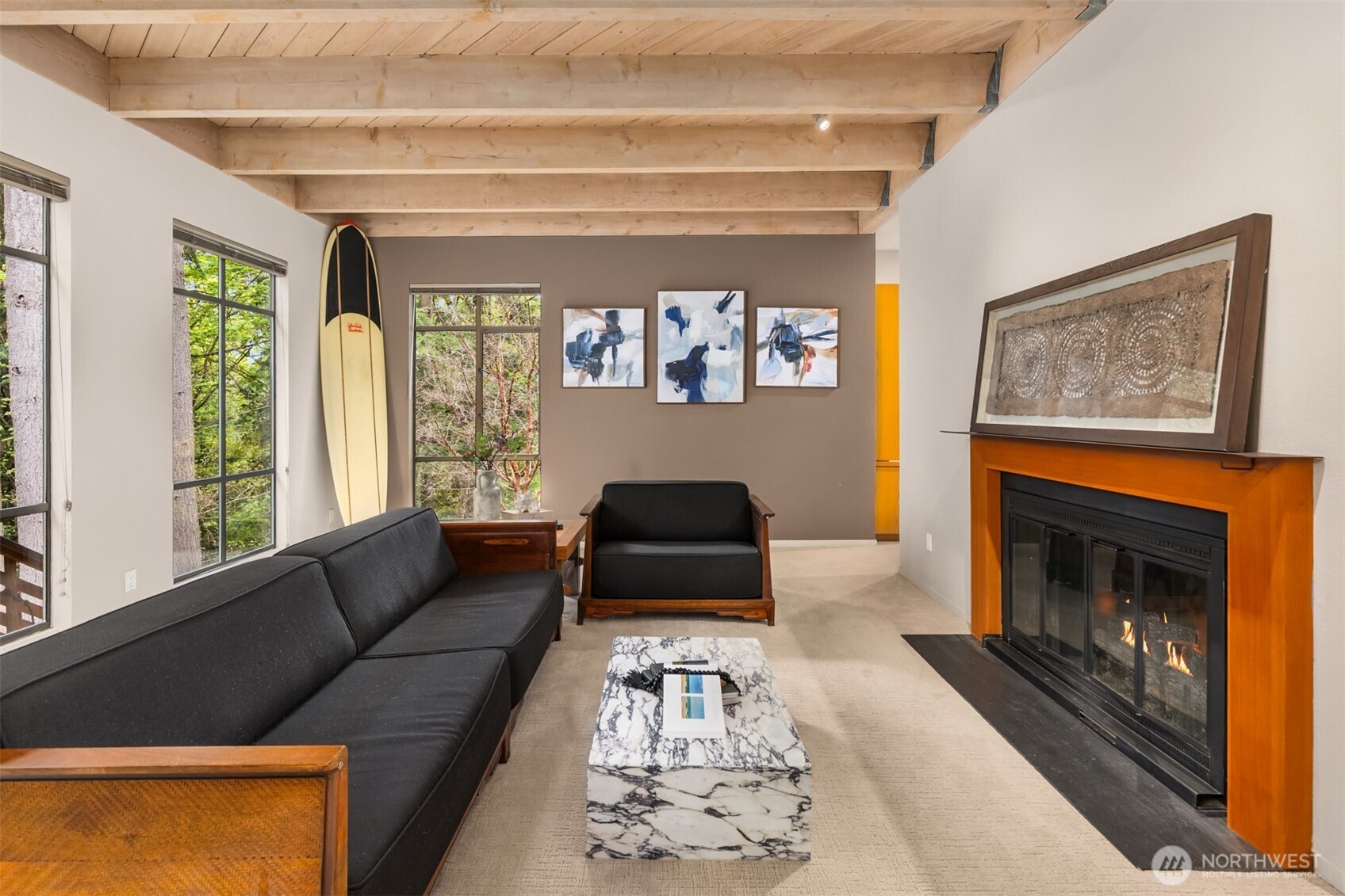 8151 Northeast Hidden Cove Road Bainbridge Island, WA 98110 - Photo 4 of 40 a living room with furniture and a fireplace
