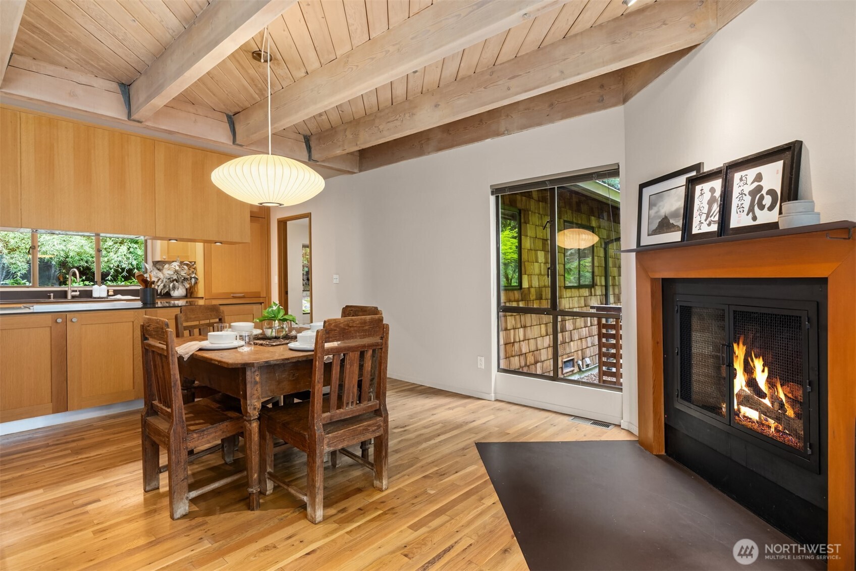 8151 Northeast Hidden Cove Road Bainbridge Island, WA 98110 - Photo 10 of 40 a view of a dining room with furniture window and wooden floor